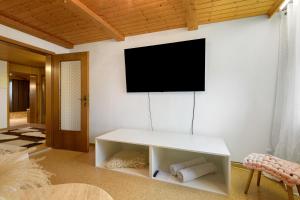 a living room with a tv on a wall at Bayernseele - Bayerwald in Spiegelau