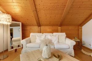 a living room with a white couch and a table at Bayernseele - Bayerwald in Spiegelau