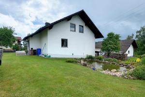 a white house with a yard in front of it at Bayernseele - Bayerwald in Spiegelau