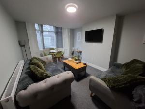 a living room with a couch and a table at Alice House Long stays in Sunderland