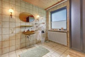 a bathroom with a sink and a mirror at Bayernseele - Bayerwald in Spiegelau +32 photos