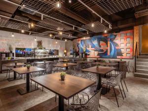 a restaurant with tables and chairs and a bar at ibis Styles Ljubljana Centre in Ljubljana