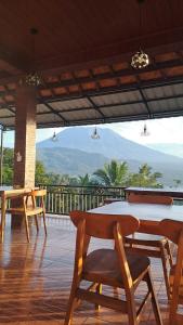 a table and chairs on a deck with a view at Double view point sibetan in Tenganan
