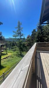 a wooden platform with a view of a field at Chalet Rec Fred in Matemale