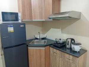 a small kitchen with a sink and a refrigerator at Avida Towers Riala, Tower 5 in Cebu City