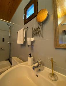 a bathroom with a sink and a mirror at Bohemian Chalet in Buşteni +71 photos