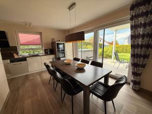 a kitchen and dining room with a table and chairs at Villa Fleesenstrand in Göhren-Lebbin