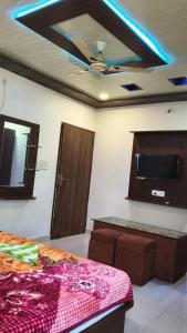 a room with a bed and a ceiling fan at Hotel Diamond in Gwalior