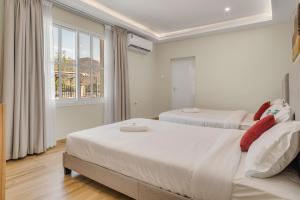 a bedroom with two beds and a window at 800 Mountains view in Fujairah