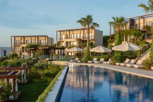 an exterior view of a resort with a swimming pool at Allium Bodrum Resort & Spa in Yalıkavak