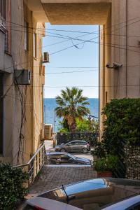an alley with a view of the ocean from a building at Palm Beachfront Suites by PS in Durrës