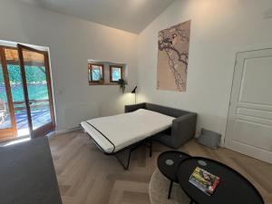 a room with a bed in the corner of a room at Logis Fontaines in Champagnat