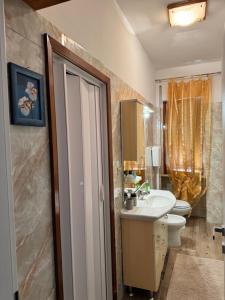 a bathroom with a sink and a toilet at La casetta di Nino in Termoli