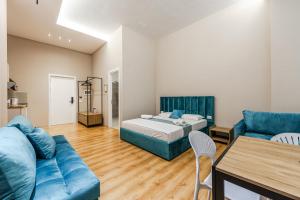 a living room with a bed and a couch at Palm Beachfront Suites by PS in Durrës