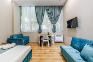 a living room with a couch and a table at Palm Beachfront Suites by PS in Durrës