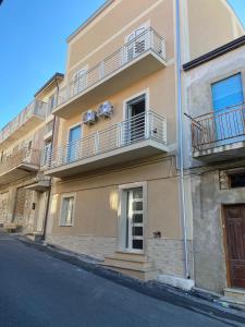a building with balconies on the side of a street at Casa vacanze Da Fra in Cariati