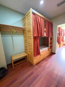 a room with a bunk bed with a bench in it at Sahil Bay Hostel in Baku