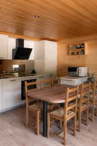 a kitchen with a wooden table and chairs at Chardonneret 3 in La Clusaz