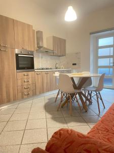 a kitchen with a table and chairs in a room at Casa vacanze Da Fra in Cariati +10 photos