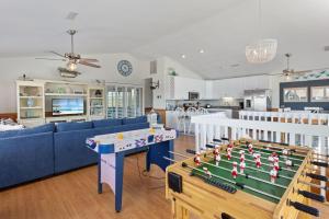 a living room with a table and a pool table at 1030 - La Ballena Cottage in Corolla +69 photos