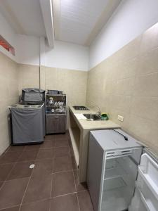 a small kitchen with a sink and a stove at SANTYS HOUSE MELGAR apartamento amoblado 6 Huéspedes in Melgar +18 photos
