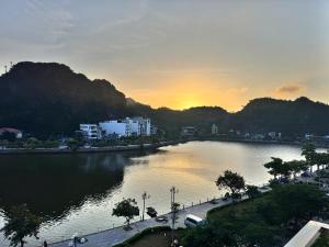 a view of a river with a city and mountains at Oriio Hotel in Cat Ba