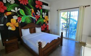 a bedroom with a bed with a floral wall at Bayahibe Premium Pool in Bayahibe +54 photos