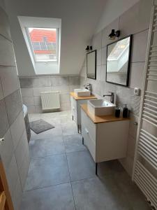a bathroom with two sinks and a mirror at Apartmán U nás na vsi in Nový Jáchymov