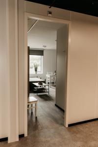 an open hallway with a room with a table at Work and Stay in Maasbree +9 photos