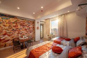 a bedroom with two beds and a wall mural at Ulaanbaatar Heritage Stay in Ulaanbaatar