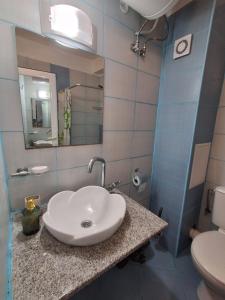 a bathroom with a sink and a toilet at Студио C19 в к-с Blue Bay Palace in Pomorie +13 photos