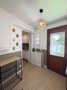 a living room with a door and a kitchen at Mon petit cocon Seurrois in Seurre +4 photos