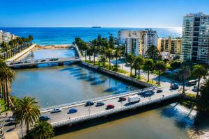 an aerial view of a city with palm trees and the ocean at LRH Viña del Mar and Convention Center - Ex Gala Hotel in Viña del Mar