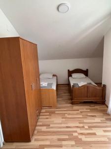 a small room with two beds and a cabinet at Apartman Savo in Kotor