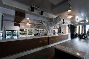 a bar with a fake tree on the wall at Hotel Elegance NV in Paramaribo