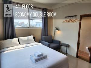 a hotel room with a bed and a chair at Lo-Ha Guest house, Contactless Check-in in Bangkok