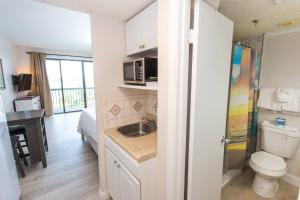 a small bathroom with a sink and a toilet at Pirates Bay Condominiums Unit 302A in Fort Walton Beach