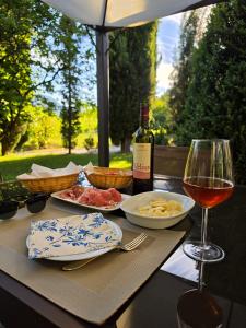 a table with a bottle of wine and a glass of wine at Podere Pradarolo in Varano deʼ Melegari