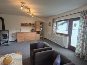 a living room with a couch and a chair at Ferienwohnung Schautzgy in Reutte