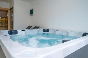 a hot tub with blue water in a room at Holiday home Mirage in Sukošan +41 photos