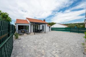 a patio of a house with a fence at Holiday home Mirage in Sukošan
