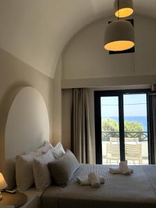 ein Schlafzimmer mit einem Bett und Meerblick in der Unterkunft Sellada Beach in Perissa + 84 Fotos