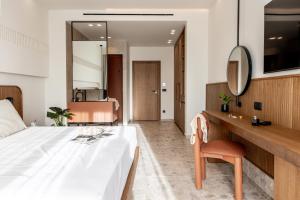 a hotel room with a bed and a mirror at Kakkos Terra Blu Hotel in Ierapetra +4 photos