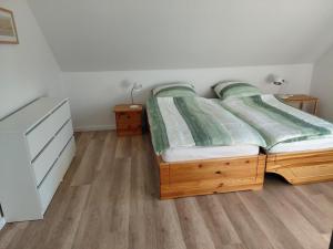 a bedroom with a bed and a dresser at Ferienwohnung Knoll in Lähden