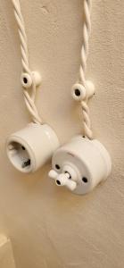 two security cameras hanging on a wall with ropes at Mas de Mingall in Les tres Cales