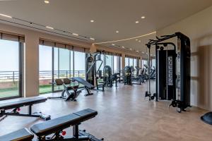a gym with a lot of treadmills and machines at Kakkos Terra Blu Hotel in Ierapetra