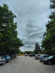 a parking lot with a lot of cars parked at Cozy apartment in Bitola in Bitola +8 photos