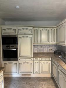 a kitchen with white cabinets and a sink at Meisehof in Buchholz Aller