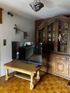 a room with a table and a large wooden cabinet at Meisehof in Buchholz Aller