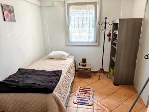 a small bedroom with a bed and a window at GRANDE PLAGE A 50 Métres in Valras-Plage